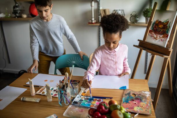 istock Creative kids enjoying making art with watercolors at home 1250468273
