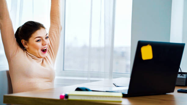 istock Successful office girl raising hands with joy 1250470176