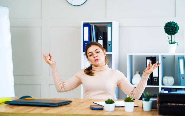 istock Young girl meditating in zen pose at workplace 1250470222