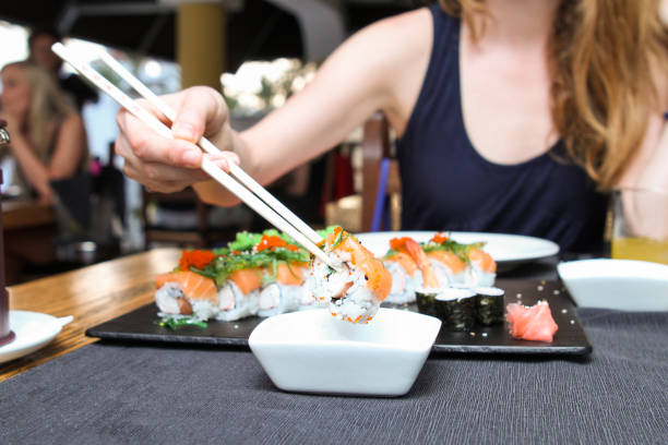 istock Sushi roll dipping in soya sauce 1250472289