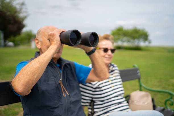 istock senior couple watching birds with binocular 1250472670