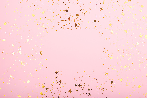 A bodrer made with falling confetti on pink background. Perfect for festive and holidays projects. Copy space for your text.