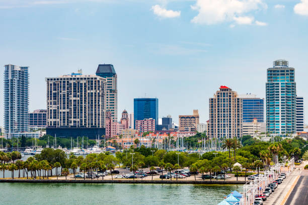 As viewed looking westward from Tampa Bay over a landscaped parking lot and a marina , we see the Skyline of Saint Petersburg, Florida circa 2010 stock photo
