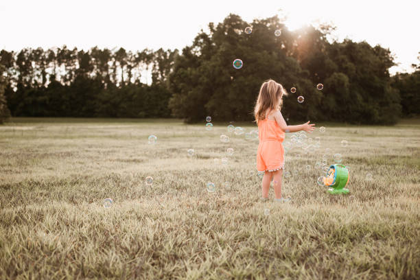 istock Girl playing with soap bubbles 1250475911