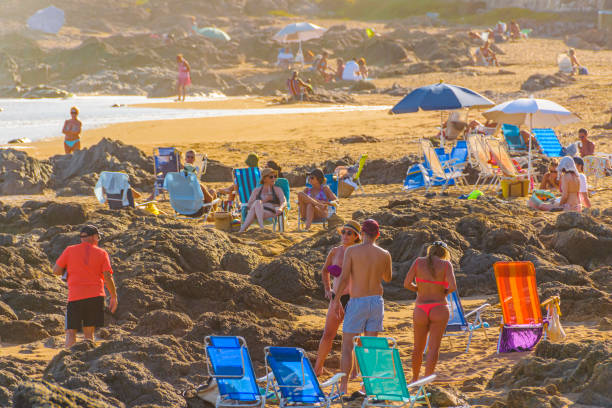 El Emir Beach, Punta del Este, Uruguay PUNTA DEL ESTE, URUGUAY, FEBRUARY - 2020 -  Summer scene at crowded rocky el emir beach in punta del este city, Uruguay playas del este stock pictures, royalty-free photos & images