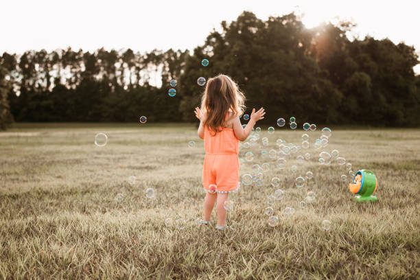 istock Girl playing with soap bubbles 1250476322
