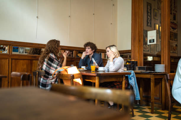 istock Friends talking and enjoying coffee at cafe 1250476594