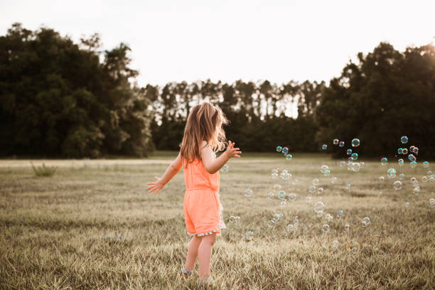 istock Girl playing with soap bubbles 1250476858