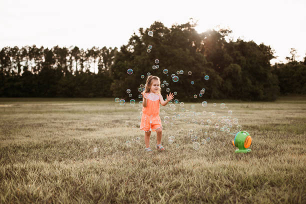 istock Girl playing with soap bubbles 1250477977