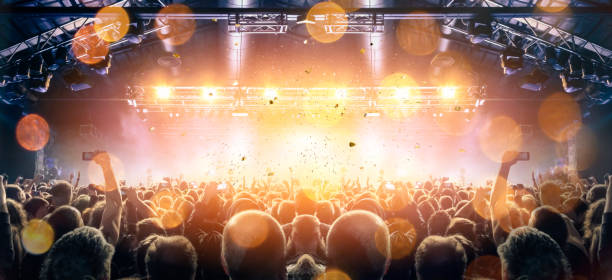 istock Concert stage, people are visible waving and clapping, silhouettes are visible 1250478002