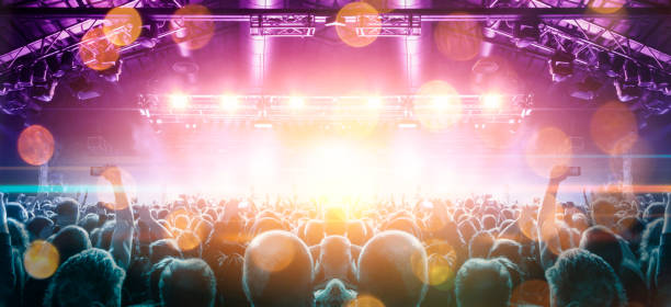 istock Concert stage, people are visible waving and clapping, silhouettes are visible 1250478004