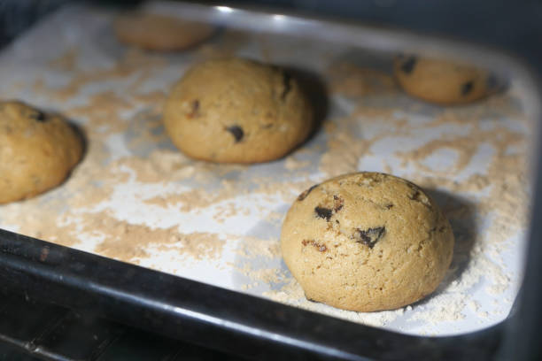 istock Tasty cookies with chocolate chips on baking tray 1250479776