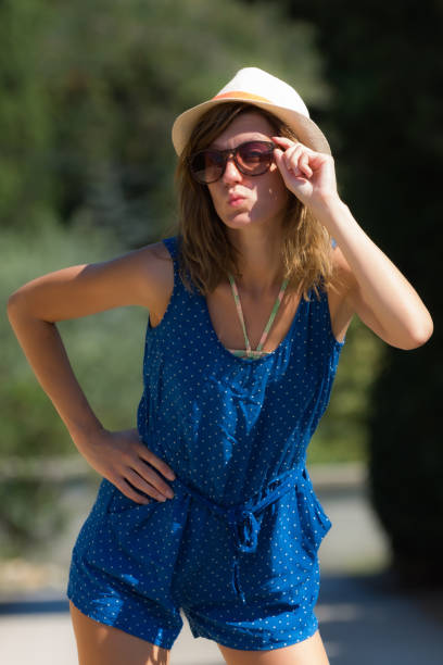 istock Cute young woman posing outdoors in summertime sunlight. 1250479971
