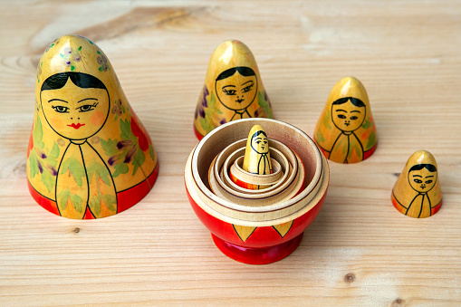 group of russian dolls on wooden table