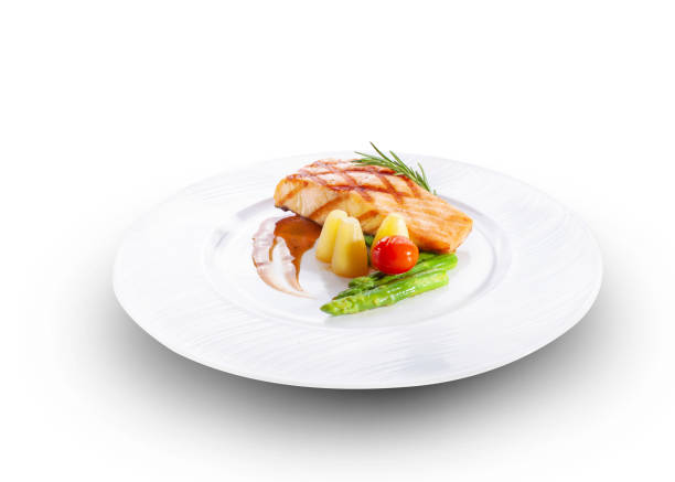 Grilled salmon fillets and fresh fruit and vegetable salad, isolated on white.