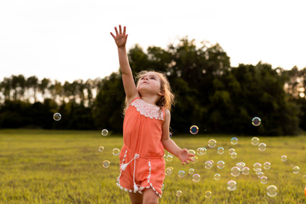 istock Girl playing with soap bubbles 1250481248