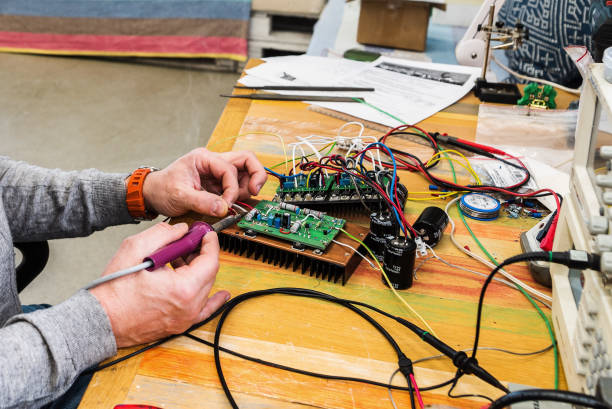 istock Electronic engineer works with a soldering iron. Work tools and equipment 1250483255
