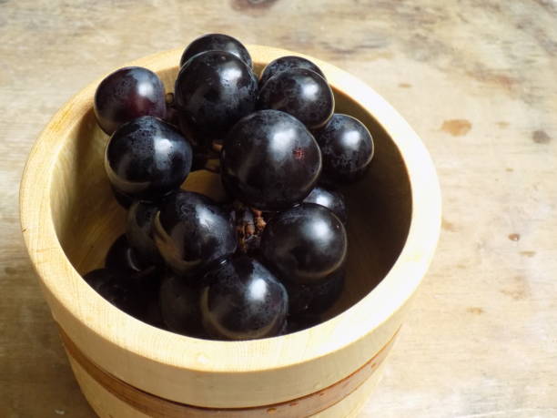 istock Black grapes in wooden container 1250484671