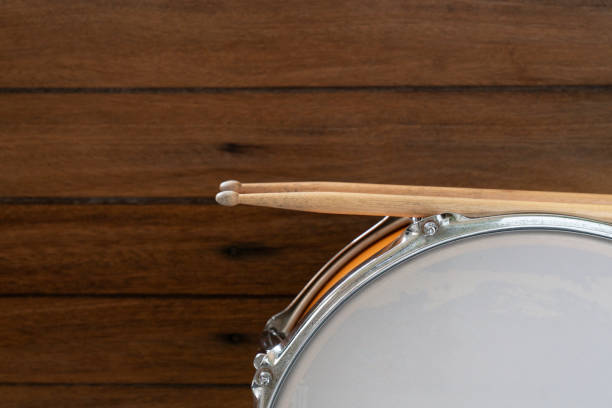 istock Drum and drum stick on wooden table background, top view, music concept 1250486264