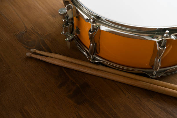 istock Drum and drum stick on wooden table background, top view, music concept 1250486291