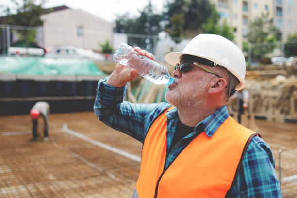 istock Portrait of a worker, an engineer resting and drinking water after hard work on a construction site 1250488047