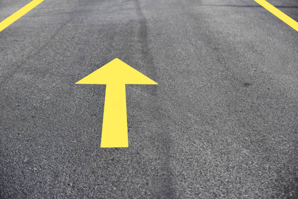istock Yellow arrow on asphalt road surface 1250488211