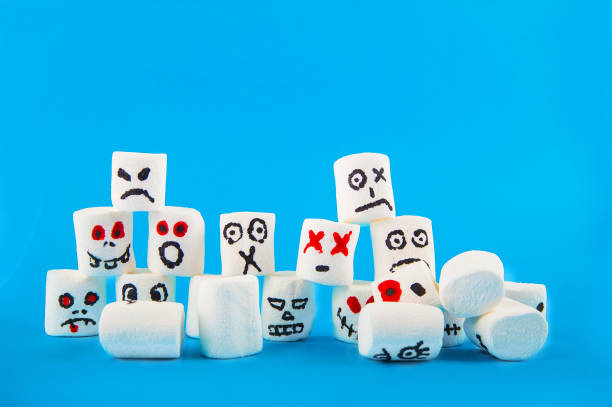 istock Marshmallows close-up and copy space on blue background. Marshmallows for Halloween emoticons. 1250489574