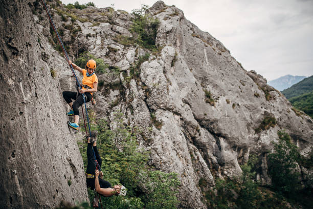istock Two women free climbers climbing on the rock mountain 1250491028