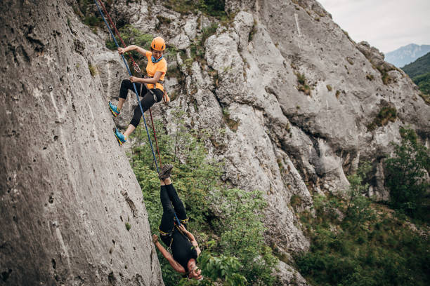 istock Two women free climbers climbing on the rock 1250491070