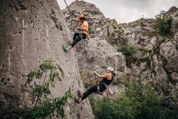 istock Two athletic female rock climbers 1250491572