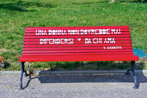 red bench against violence for women I translate from Italian to English: a woman should never defend herself from those she loves. Imperia Italy