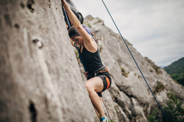 istock One athletic woman climbing high 1250493100