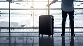 Tourist man holding suitcase luggage in airport