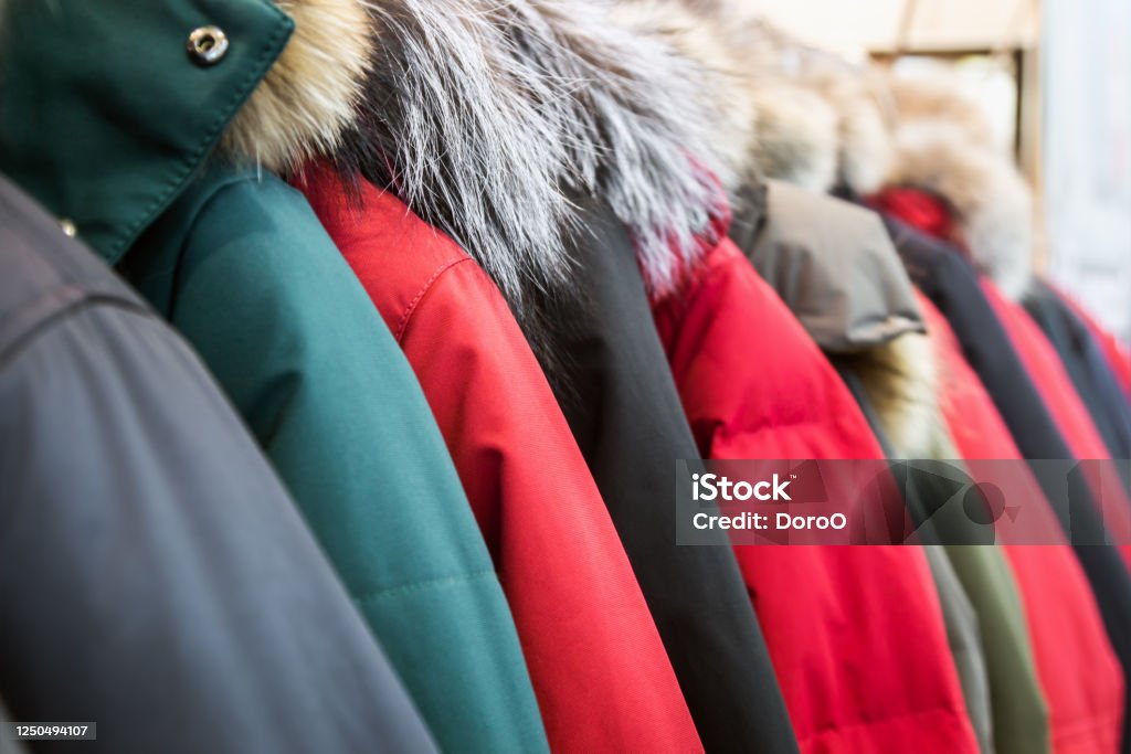 assortment of winter jackets and down jackets assortment of winter jackets and down jackets on store hangers. Coat - Garment Stock Photo