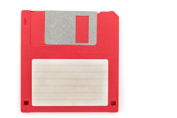 Red floppy disk with blank label on white background