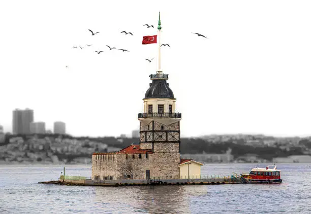 Istanbul Maiden's Tower, only tower and the sea is colored, rest of the background are monochrome and out of focus, turkish flag is waving