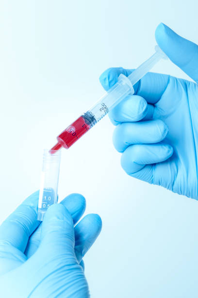istock Hand with blue glove holding a syringe 1250500958