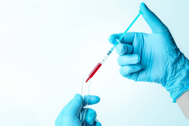 istock Hand with blue glove holding a small syringe 1250500992