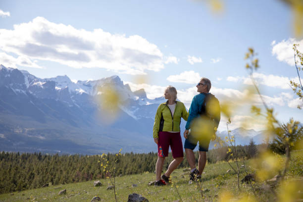 istock Mature couple hike along grassy slope 1250501228