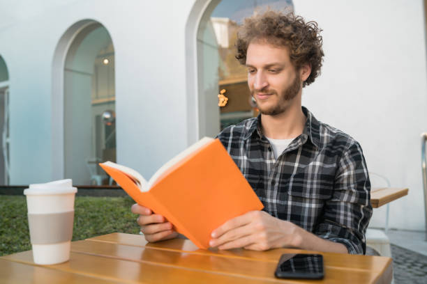 istock Man enjoying free time and reading a book. 1250502971