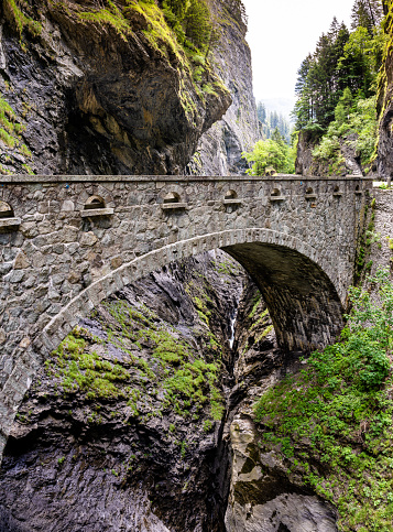 The historic stone bridge crossing the deep Viamala Gorge in the Swiss Alps near Thusis