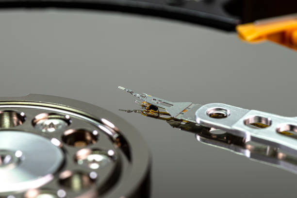 istock Macro shot of a magnetic needle on a hard disk platter, open HDD disk, perfectly clean surface. 1250505602