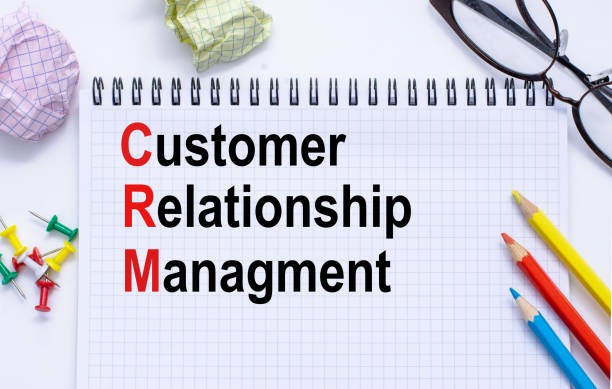 istock CRM customer relationship management abbreviation in Notepad, pens,glasses, paper clips. Business content. 1250505836