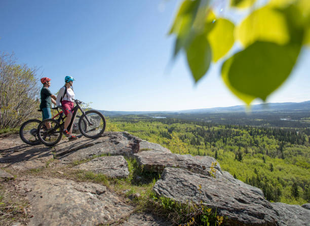 istock Couple on mountain e-bikes relax on mountain ridge 1250509841