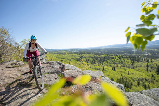 istock Female mountain e-biker rides along mountain ridge 1250511397