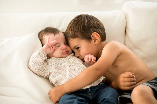 istock Little boy hugging his younger sibling 1250512463