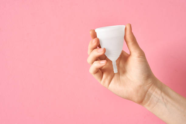 istock Menstrual cup eco friendly reusable and silicone in woman's hand isolated on a white background 1250515317
