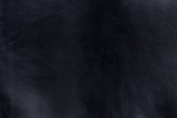 istock Black smooth natural leather in small grain textured background 1250515400