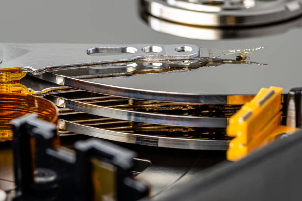 istock Macro photo of a magnetic needle on a hard disk, an open HDD with three plates. 1250515708