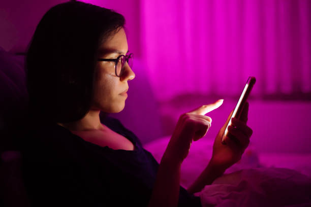istock Woman laying in bed and using smart phone 1250516656